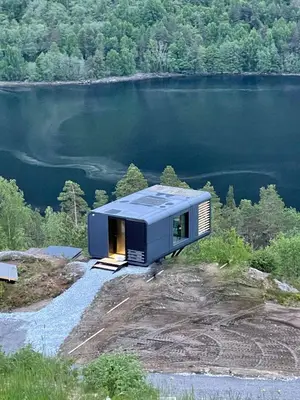 a tiny house on top of a hill next to a lake at Sogndal Fjordpanorama - The view in Sogndal