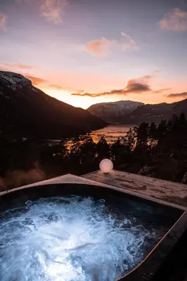 a hot tub with a view of the mountains at Sogndal Fjordpanorama - The view in Sogndal