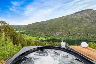 a room with a view of a lake and mountains at Sogndal Fjordpanorama - The atmosphere in Sogndal