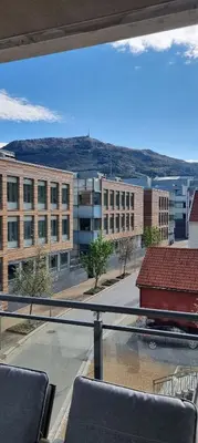 a view from the balcony of a building with a train at Modern Apartment - Amazing Terrace and Fjord View, Close to City Center in Bergen