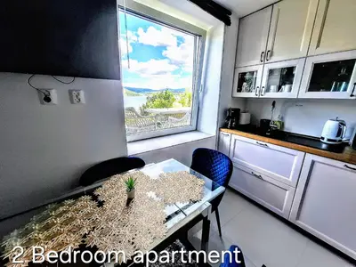 a small kitchen with a table and a window at Bergen sunrise Apartment - self check in - Free Parking in Bergen