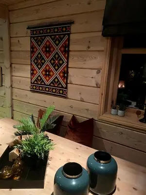 a wooden table with two blue vases on top of it at Hytto in Håra