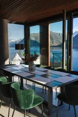 a dining room with a table and chairs with a view at VILLA KRISTINA / ÅNDALSNES in Torvik