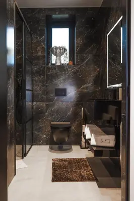 a black bathroom with a toilet and a window at VILLA KRISTINA / ÅNDALSNES in Torvik