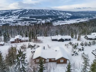 an aerial view of a snow covered cabin at ReveEnka - cabin in Trysil with Jacuzzi for rent in Trysil