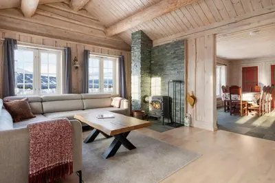 a living room with a couch and a table at ReveEnka - cabin in Trysil with Jacuzzi for rent in Trysil