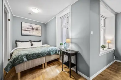 a bedroom with a bed and a side table at Dragesmauet Apartments in Bergen