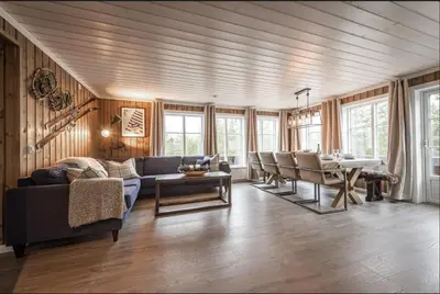 a living room with a couch and a table at Cabin with sauna in Trysil in Trysil