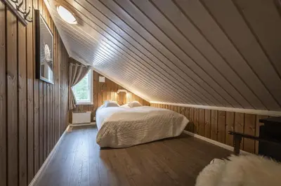 a bedroom with a large bed in a attic at Cabin with sauna in Trysil in Trysil