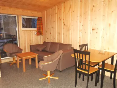 a living room with a couch and a table at Lensmansgarden Fjøsen in Innfjorden