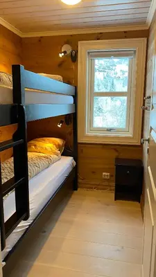 a bedroom with a bunk bed and a window at Penthouse by the ski lift, 4 bedrooms, 2 living rooms in Stranda