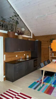 a kitchen with wooden cabinets and a table with chairs at Penthouse by the ski lift, 4 bedrooms, 2 living rooms in Stranda