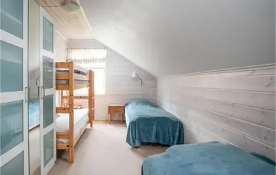 a bedroom with two bunk beds and a ladder at Cozy Home In Vanvik With Wifi in Vanvik