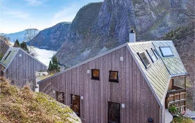 a house on a hill with a mountain in the background at 4 Bedroom Gorgeous Home In Erfjord in Erfjord