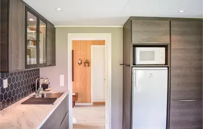 a kitchen with a refrigerator and a microwave at 5 Bedroom Lovely Home In Bjoa in Utbjoa