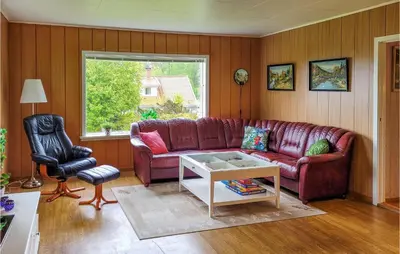 a living room with a red couch and a table at Gorgeous Home In Reksteren With Kitchen in Hope
