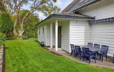 a table and chairs on the side of a house at Gorgeous Home In Reksteren With Kitchen in Hope