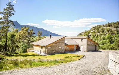a home in the mountains with a gravel driveway at Amazing Home In Etne With Wifi in Erve