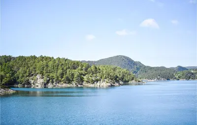 a large body of water with trees on the shore at Gorgeous Home In Reksteren With Kitchen in Klinkholmen