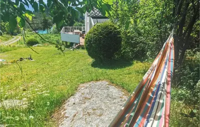 a fence with an american flag on it in a yard at Lovely Home In Fjelberg With Wifi in Sæbø