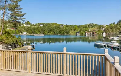 a boat is docked at a dock on a lake at Cozy Home In Sveio With Wifi in Sveio