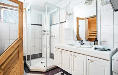 a bathroom with a shower and a sink at Sjøbris in Erve