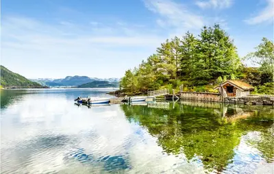 a couple of boats in the water on a lake at Awesome Home In Etne With Sauna in Erve