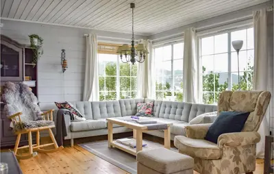 a living room with a couch and a table at Beautiful Home In Jondal in Jondal