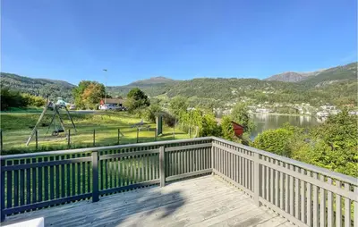 a balcony with a view of a lake and mountains at Cozy Home In Ulvik With Wifi in Ulvik