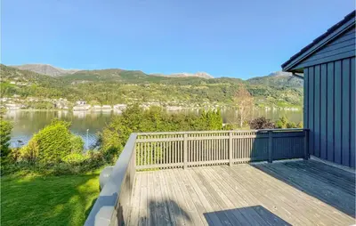 a large deck with a view of a lake at Cozy Home In Ulvik With Wifi in Ulvik