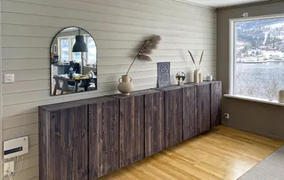 a room with a mirror and a wooden wall at Cozy Home In Ulvik With Wifi in Ulvik