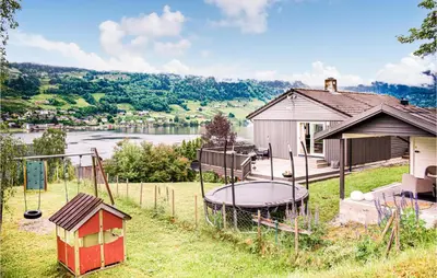 a house with a playground next to a house at Cozy Home In Ulvik With Wifi in Ulvik
