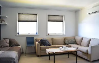 a living room with a couch and a table at 3 Bedroom Amazing Home In Norheimsund in Norheimsund