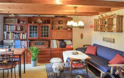 a living room with a blue couch and a table at Amazing Home In Fonnes With Wifi in Fonnes