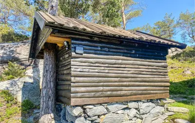 a log cabin with a roof on a tree at 3 Bedroom Stunning Home In Masfjorden in Masfjorden