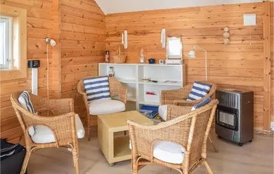 a living room with wicker chairs and a tv at 3 Bedroom Stunning Home In Masfjorden in Masfjorden