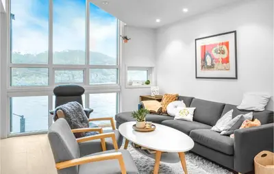 a living room with a couch and a table at Gorgeous Home In Stolmen With Kitchen