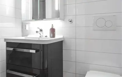 a white bathroom with a sink and a mirror at Gorgeous Home In Stolmen With Kitchen
