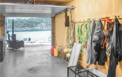 a room with a door leading to the beach at Gorgeous Home In Stolmen With Kitchen