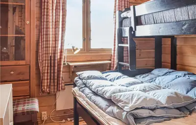 a bed sitting in a room with a window at 3 Bedroom Amazing Home In Vossestrand in Vossestrand