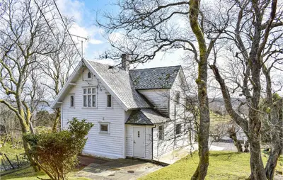 a white house in the middle of some trees at Amazing Home In Torangsvåg With Wifi in Skår