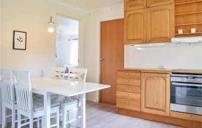 a kitchen with a white table and chairs at Amazing Home In Torangsvåg With Wifi in Skår