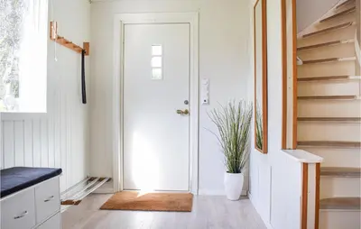 a hallway with a white door and a plant at Amazing Home In Torangsvåg With Wifi in Skår