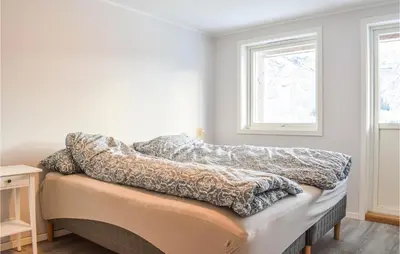 a room with a bed covered in blankets at Lovely Home In Masfjordnes With Wifi in Masfjorden