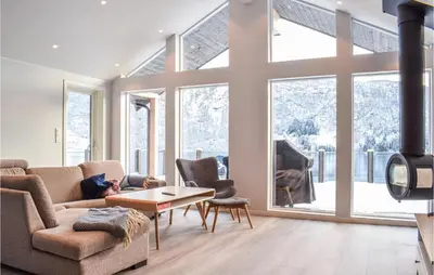 a living room with a couch and a table at Lovely Home In Masfjordnes With Wifi in Masfjorden