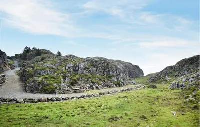 a rocky hillside with a dirt road in a field at 2 Bedroom Cozy Home In Stolmen