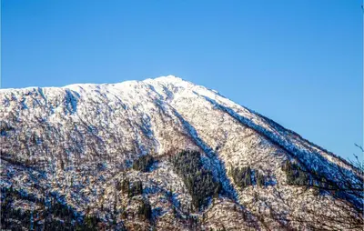 a snow covered mountain with a blue sky in the background at Cozy Home In Bruvik With Wifi in Bruvik