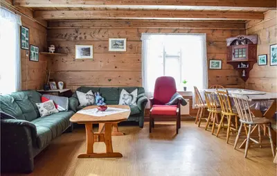 a living room with a couch and a table at Pet Friendly Home In Evanger in Evanger