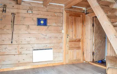 a room with a wooden wall with a white box at Pet Friendly Home In Evanger in Evanger
