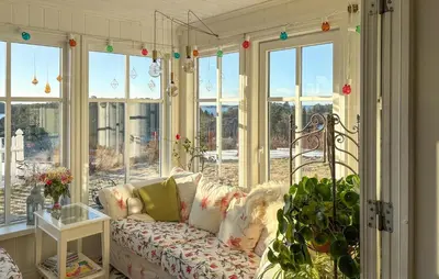 a living room with a couch in front of windows at Gorgeous Home In Fjell With Wifi in Lokøy